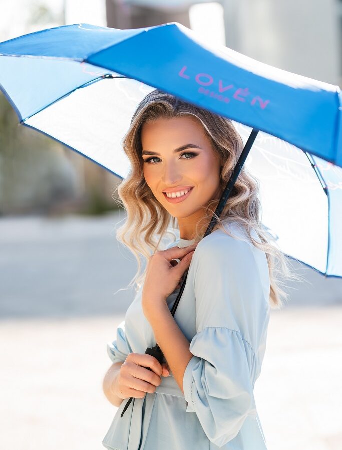 woman holding blue umbrella